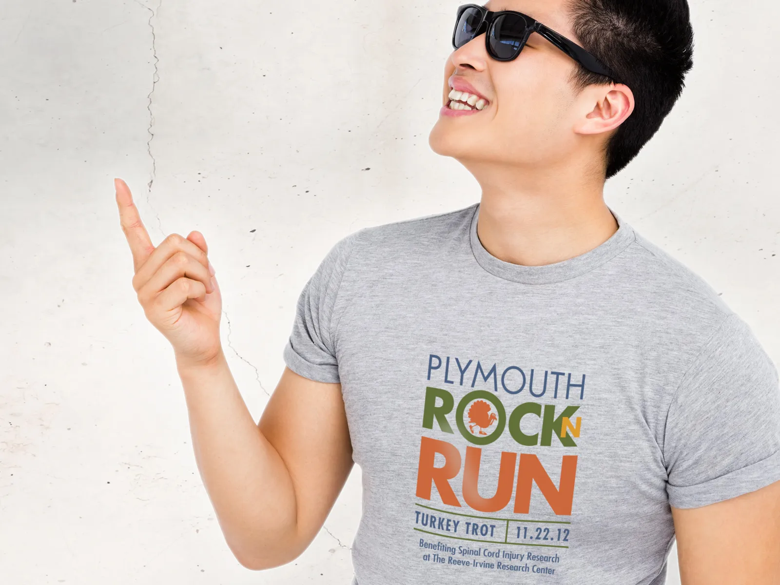 Smiling man wearing a Plymouth Rock Run T-shirt